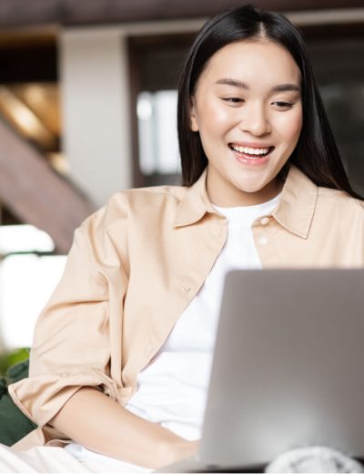 happy-asian-woman-resting-at-home-with-laptop-wat-2022-08-14-04-58-22-utc